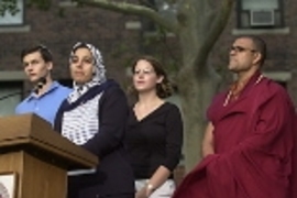 Representing their faiths at the podium are (left to right) Andrew Goldsweig, a Jewish senior in chemistry; Sarah Saleh, a Muslim graduate student in aeronautics and astronautics; Maureen Long, a graduate student in earth, atmospheric and planetary sciences, representing Christian traditions; and Buddhist Priyadarshi Shukla of the Harvard Divinity School.