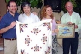Organizers of the Crete workshop presented gifts to Shuguang Zhang, lead organizer of the conference, at a final banquet. Left to right: Michael Hecht, Zhang, Amalia Aggeli and Neville Boden display cloths bearing traditional Greek designs in patterns Hecht playfully called "self-assembled."