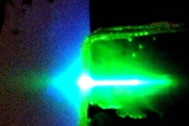 A sensor film made of a novel semiconducting organic polymer undergoes a lasing process when exposed to ultraviolet light. When TNT is present, it binds to the polymer and quenches the beam.