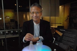 Hiroshi Ishii with one of his early projects, bottles that play music when their stoppers are removed.
