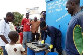Community members attend a training session to learn how to keep the new Sanergy pilot toilets spotlessly clean.