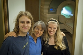 From left, MIT undergraduate Michael Behr, principal investigator Nancy Kanwisher and research scientist Evelina Fedorenko in front of the fMRI machine they use to measure real-time brain activity associated with language and other cognitive tasks.