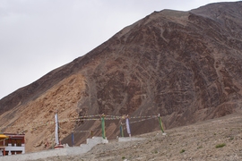 A typical Ladakhi house near Taruk, where a young granite (white) intruded rocks that were originally deposited in the Shyok Sea (black), an ocean that formed between Eurasia and the Kohistan Ladakh Island Arc.