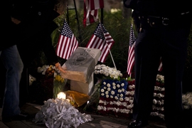 At the conclusion of the vigil, attendees laid their candles at the base of the memorial stone.
