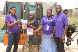 A local woman exchanges points she earned for recycling through Wecyclers for food. 