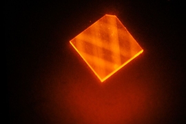 In this image, laser light enters a synthetic diamond from a facet at its corner and bounces around inside the diamond until its energy is exhausted. This excites "nitrogen vacancies" that can be used to measure magnetic fields.
