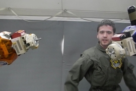 MIT Space Systems Laboratory graduate student Duncan Miller carries out tests of SPHERES satellites with the Universal Docking Port on a flight aboard NASA’s reduced gravity aircraft in 2014.