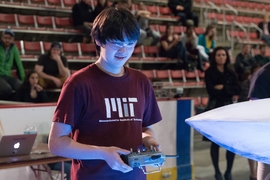 A student competes in the 2017 MIT Mechanical Engineering 2.007 Student Design Final Robot Competition.