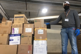 A staff member from Cambridge Health Alliance accepts a delivery from MIT.