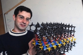 Mechanical Engineering Professor Tonio Buonassisi holds model illustrating problems with solar cells he is working on (in blue).