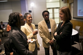 Fiona Murray (right), associate dean for innovation at MIT Sloan, speaks with attendees at MIT's conference on social impact investing on May 14.