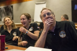 (From right to left): Members of the New Horizons science team, including MIT Professor Richard Binzel, graduate student Alissa Earle (MIT), and Cristina Dalle Ore (SETI Institute), react to seeing the spacecraft's last and sharpest image of Pluto before closest approach later in the day.